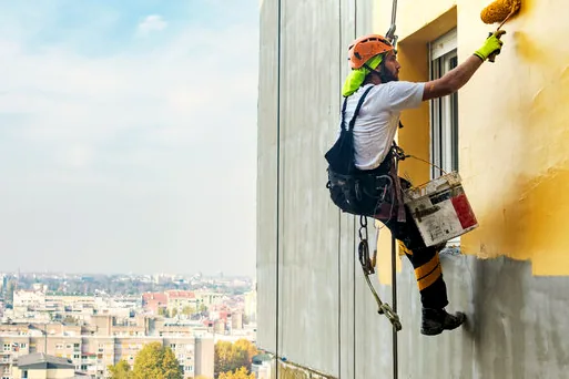 Rope-access painter on a tall building near Ocean Avenue