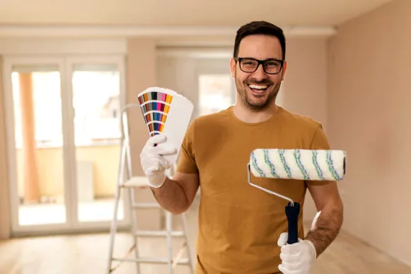 Santa Monica painter holding a roller and color deck